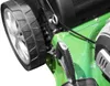 A close-up view of a green lawnmower's wheel and handle. Produktbild-Vorschau