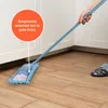 A hand is using a light blue mop with a chenille cover to clean a wooden floor next to white cabinets. Anteprima dell’immagine prodotto