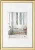A framed picture of a room interior with a chair and a small table. Produktbild-Vorschau