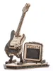 A wooden model of an electric guitar and amplifier on a display stand. Voir les images du produit