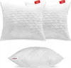 Three white pillows with a quilted pattern are displayed against a white background. Two pillows are stacked on top of each other, and one is placed below them. Produktbild-Vorschau