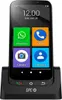 A smartphone in a charging dock with large app icons on the screen. Voir les images du produit