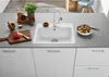 A kitchen counter with a sink, faucet, and various kitchen items. Náhľad obrázku produktu