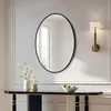 A modern hallway with a console table, a mirror, and a wall sconce. Produktbild-Vorschau