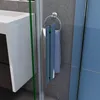 A close-up view of a shower door handle and towel rack in a bathroom. Produktbild-Vorschau