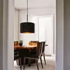 A dining room with a table and chairs, illuminated by a pendant lamp. Anteprima dell’immagine prodotto