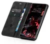 A black flip-case phone cover with cards and a banknote inserted, next to a smartphone displaying the lock screen. Produktbild-Vorschau