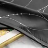 A close-up view of a black curtain with white abstract line patterns and dots. A golden frame and part of a painting are visible underneath. Produktbild-Vorschau
