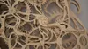 A close-up view of intricate wooden gears and mechanisms. Voir les images du produit