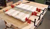 A woodworking clamp is holding together several pieces of wood on a workbench. Náhľad obrázku produktu