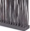 A close-up view of a room divider made of dark, thin wooden sticks standing upright in a dark wooden base. Náhled obrázku produktu