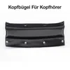 A black leather headband cushion with metal snaps, shown against a white background. Produktbild-Vorschau
