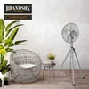 A modern living room setting with a chair, plants, and a fan. Voir les images du produit