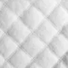A close-up of quilted white fabric. Náhled obrázku produktu