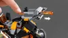 A close-up shot of a LEGO toy, with a finger pressing a part of the toy. Produktbild-Vorschau