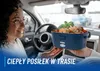 A woman in a car is holding a blue lunchbox filled with food. Produktbild-Vorschau