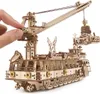 A hand is shown adjusting a wooden model of a research ship with a crane. Podgląd zdjęcia produktu