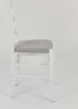 Side view of a white dining chair with a gray upholstered seat. Voir les images du produit