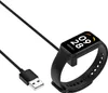 A black smart band charging cable and a black smart band are shown on a white background. Produktbild-Vorschau