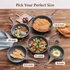 A collection of frying pans of different sizes, each containing food, arranged on a wooden surface. Produktbild-Vorschau
