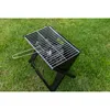 A portable grill is placed on a grassy lawn. Podgląd zdjęcia produktu