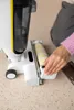 A person is shown interacting with a Kärcher Saugwischer FCV 4 Natural N on a speckled floor. Produktbild-Vorschau