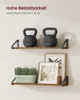 Two shelves mounted on a wall, displaying decorative items and weights. Produktbild-Vorschau