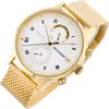 A close-up shot of a gold Tommy Hilfiger watch with a white face and a mesh band, presented against a white background. Voir les images du produit