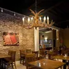 A restaurant interior with tables, chairs, and a chandelier. Podgląd zdjęcia produktu