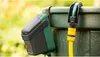 A close-up of a Bosch rain water pump unit attached to a green water butt, with a garden hose connected. Náhľad obrázku produktu