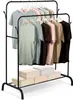 A black metal clothing rack with multiple t-shirts hanging on it, and storage boxes on the bottom shelf. Podgląd zdjęcia produktu