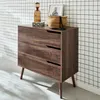 A wooden dresser with three drawers stands against a tiled wall. Produktbild-Vorschau