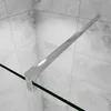 A close-up view of a shower screen support arm attached to a glass panel, with tiled walls in the background. Produktbild-Vorschau