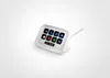 A white Elgato Stream Deck Neo device with 8 illuminated buttons displaying app icons and a small digital display showing the time and date, placed on a white stand against a white background. Náhled obrázku produktu