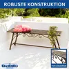 A metal garden bench with a pillow and a potted plant on a white patio. Anteprima dell’immagine prodotto