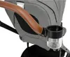 A close-up view of a stroller's handle and attached cup holder. Produktbild-Vorschau
