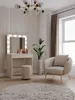 A well-lit room with a vanity table, chair, and rug. Anteprima dell’immagine prodotto