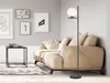 A modern living room with a sofa, coffee table, and artwork on the wall, featuring a floor lamp. Produktbild-Vorschau