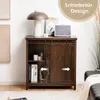 A dark brown wooden cabinet with sliding barn doors, decorated with a lamp, books, and a speaker on top. Podgląd zdjęcia produktu