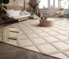 A living room scene with a rug, sofa, coffee table, and chair. Anteprima dell’immagine prodotto
