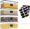 A set of four clear plastic food storage containers filled with different dry goods, stacked vertically. Each container has a black label indicating its contents. Produktbild-Vorschau