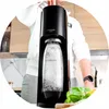 A person is using a SodaStream machine to carbonate water in a kitchen setting. Produktbild-Vorschau