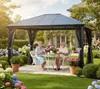An elderly couple enjoys tea under a gazebo in a garden. Produktbild-Vorschau