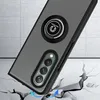 A phone case with a ring holder is shown at an angle, appearing to be dropped onto a cracked surface, suggesting its protective qualities. Produktbild-Vorschau