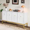 A white sideboard with gold accents is shown in a room setting, decorated with a vase of dried flowers, a bowl of fruit, a record player, and a table lamp. Anteprima dell’immagine prodotto