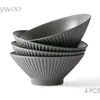 A stack of four grey ceramic bowls with a ribbed texture, presented on a white background. Produktbild-Vorschau