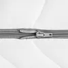 A close-up view of a zipper on a white quilted surface. Produktbild-Vorschau