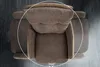 A top-down view of a swivel chair on a dark, textured surface. Produktbild-Vorschau