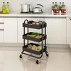 A black three-tiered kitchen cart filled with produce and jars, placed on a tiled floor in a kitchen setting. Voir les images du produit