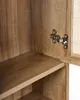 Close-up view of the interior of a wooden cabinet, showing a shelf and a metal hinge. Podgląd zdjęcia produktu